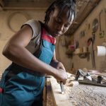 carpenter-cutting-mdf-board-inside-workshop